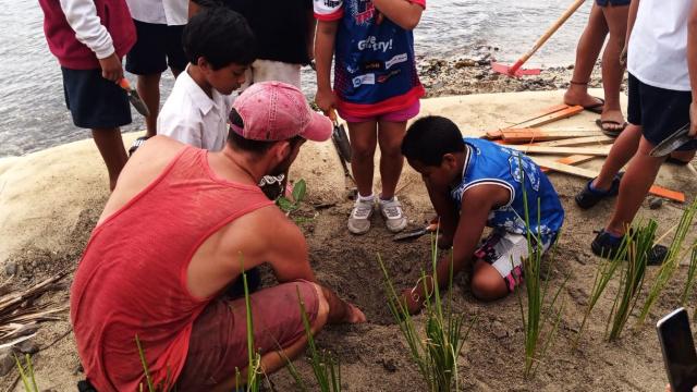 Students from Apii Takitumu and Apii Te Uki Ou planting erosion control vegetation at the Avana geobag revetment