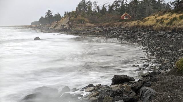 Washington’s seasonal king tides, shown here at Washaway Beach in November 2022, are becoming more destructive as sea levels rise. Local leaders have spread an experimental cobble berm along the shore to help stem erosion